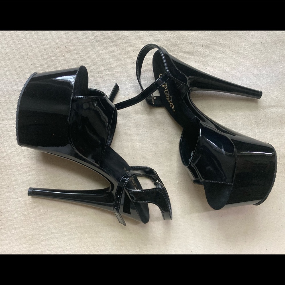 Black patent leather pleaser heels size 7 with ankle strap. Heels are 7 inch.